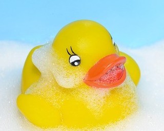 Yellow rubber duck with soap bubbles on it