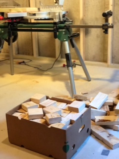 Scraps of assorted blocks of wood in box on basement floor