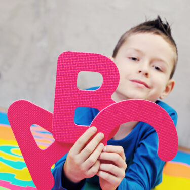 Boy holding letters ABC