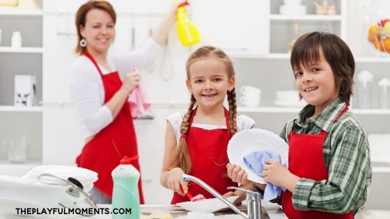 Kids washing dishes with their mother