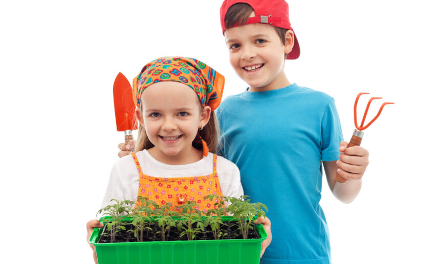 Boy and girl with a tray of seedlings