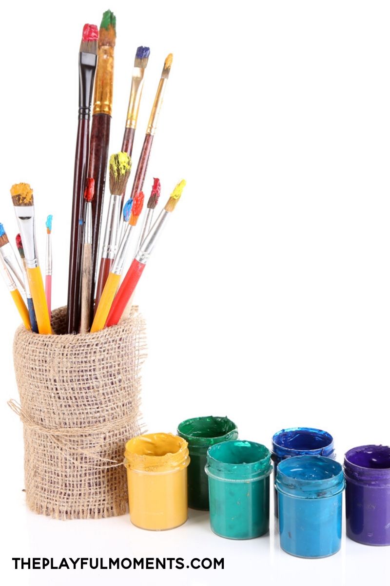 Paint brushes and jars of paint