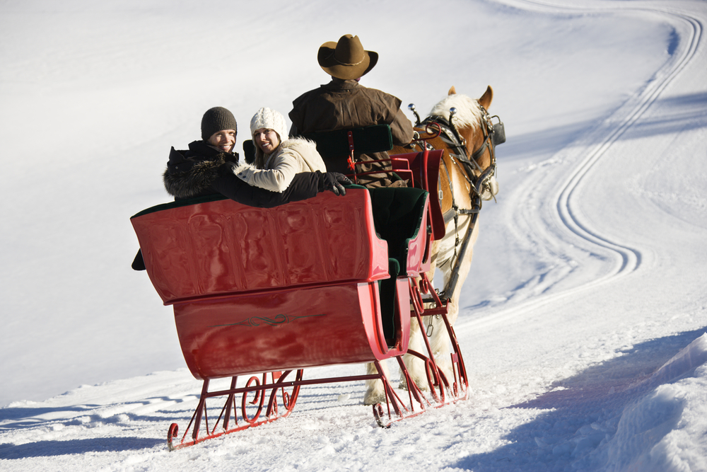 People-riding-in-sleigh-in-snow