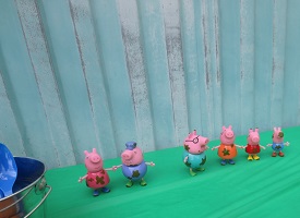 Peppa Characater Toys on table with green tablecloth