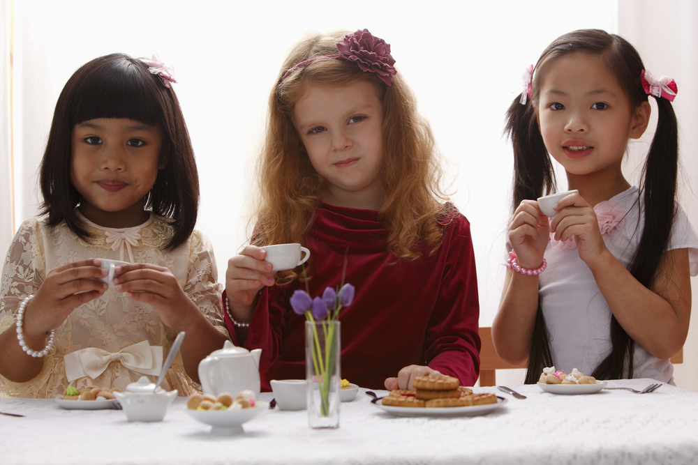 Three young girls having a tea party