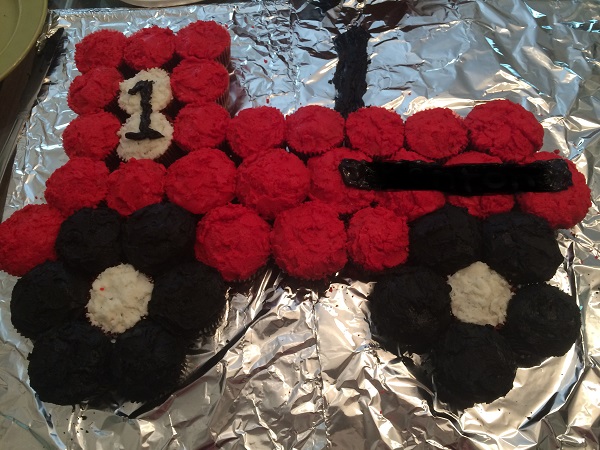 Red Farmall birthday cake made out of cupcakes with a number one on it
